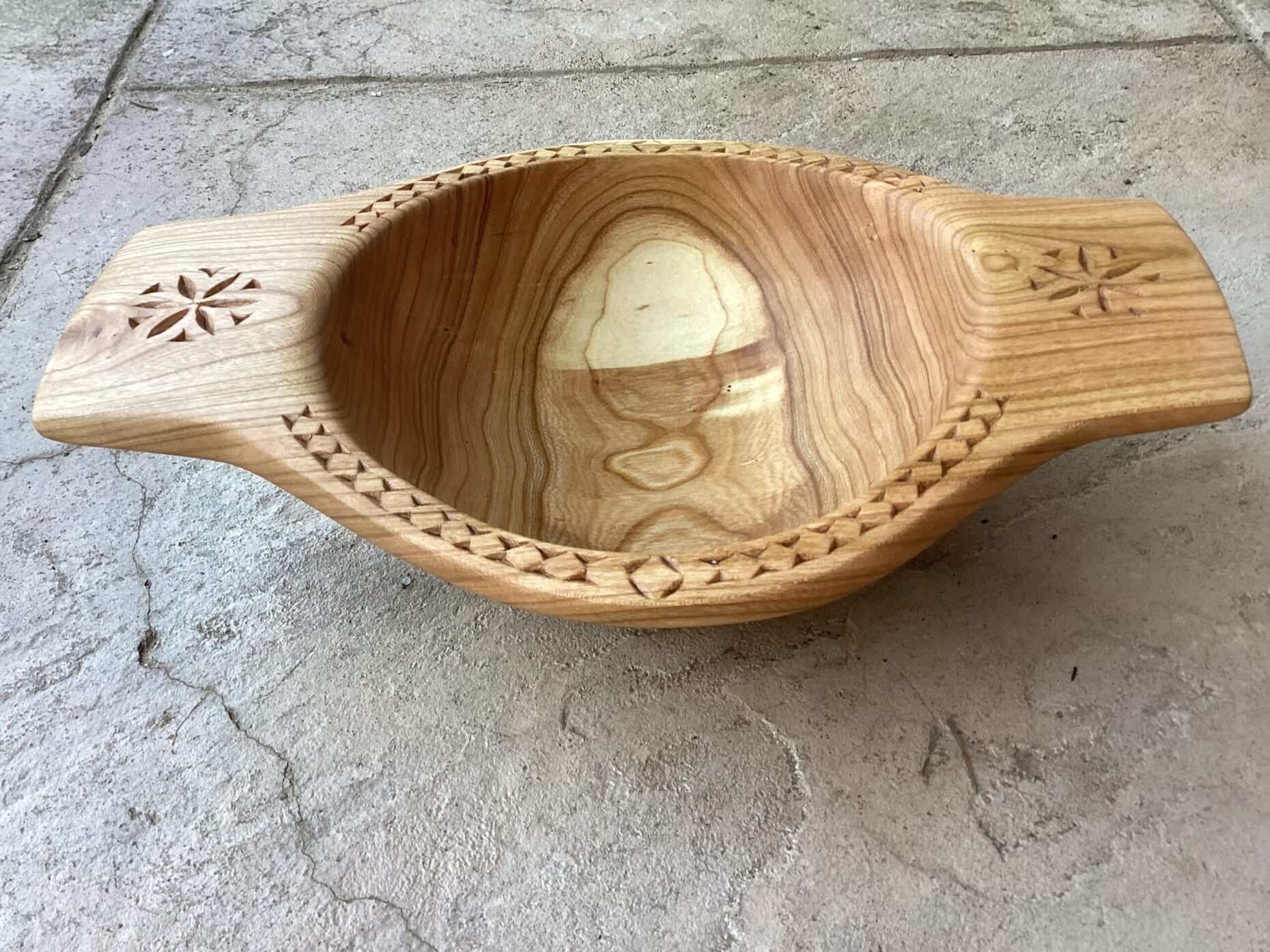 Cherry burl hand-carved bowl with decorative chip carving.