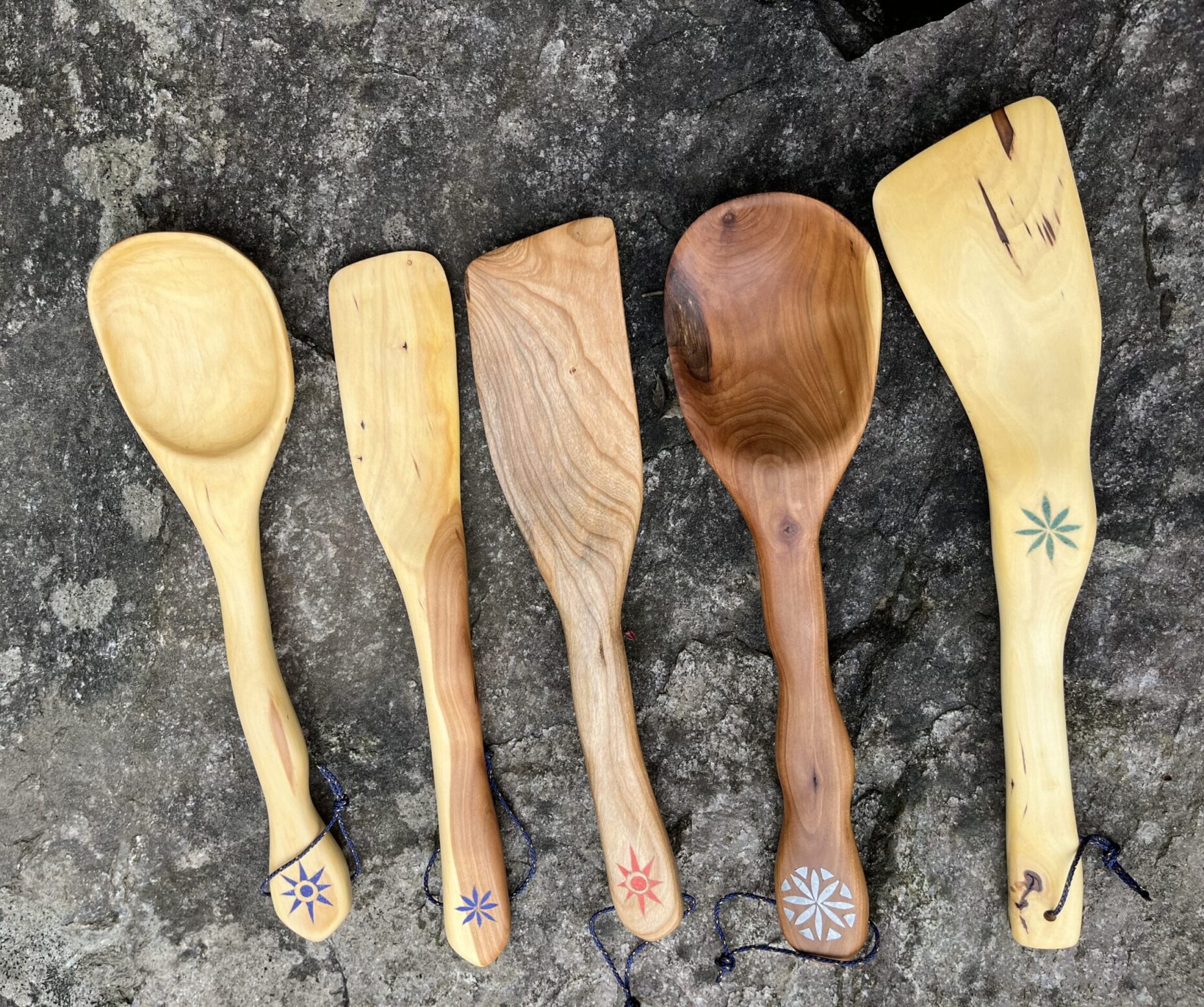 Wooden spoons and spatulas in cherry and apple wood with various inlays.